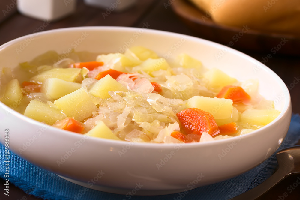 Vegetarian soup or stew made of sauerkraut, carrot and potato, photographed with natural light (Selective Focus, Focus one third into the dish) Vegetarian soup or stew made of sauerkraut, carrot and potato, photographed with natural light (Selective Focus, Focus one third into the dish)