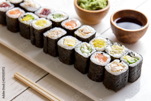 Obraz na plátně japanese food mini maki sushi platter on white wooden table