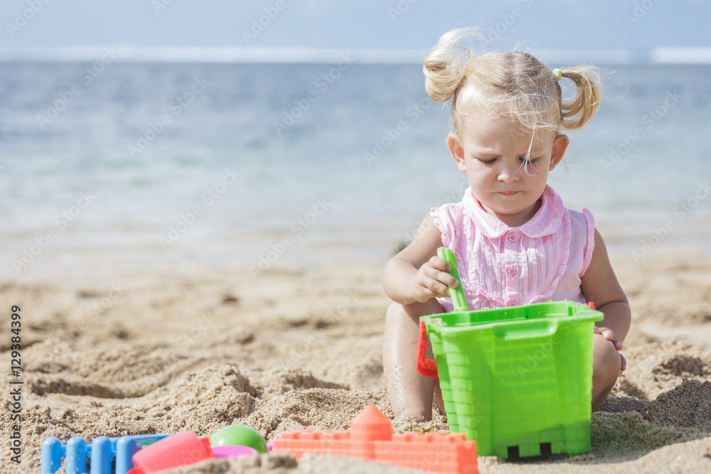 little girl playing sand toys at the beach little girl playing sand toys at the beach