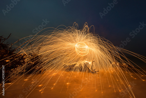 Burning steel wool spinned on the beach
