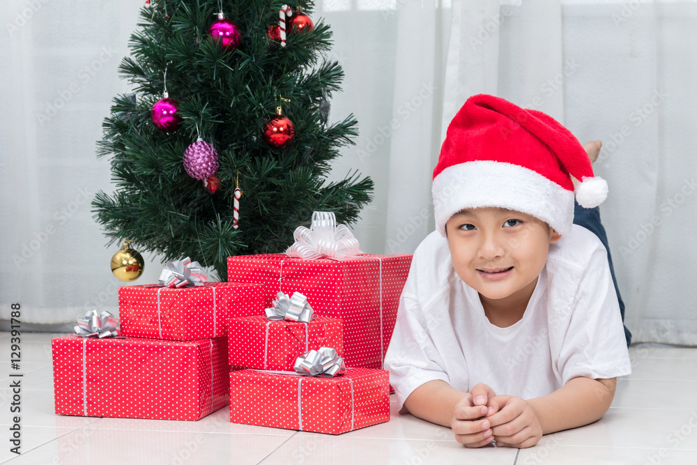 Asian Chinese little boy posing with Christmas gift box Asian Chinese little boy posing with Christmas gift box