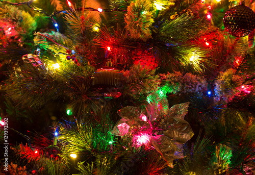 Close up of glowing lights and decorations on a Christmas tree