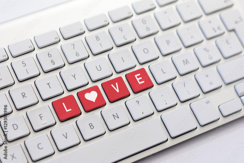 LOVE writing on white keyboard with a heart sketch LOVE writing on white keyboard with a heart sketch