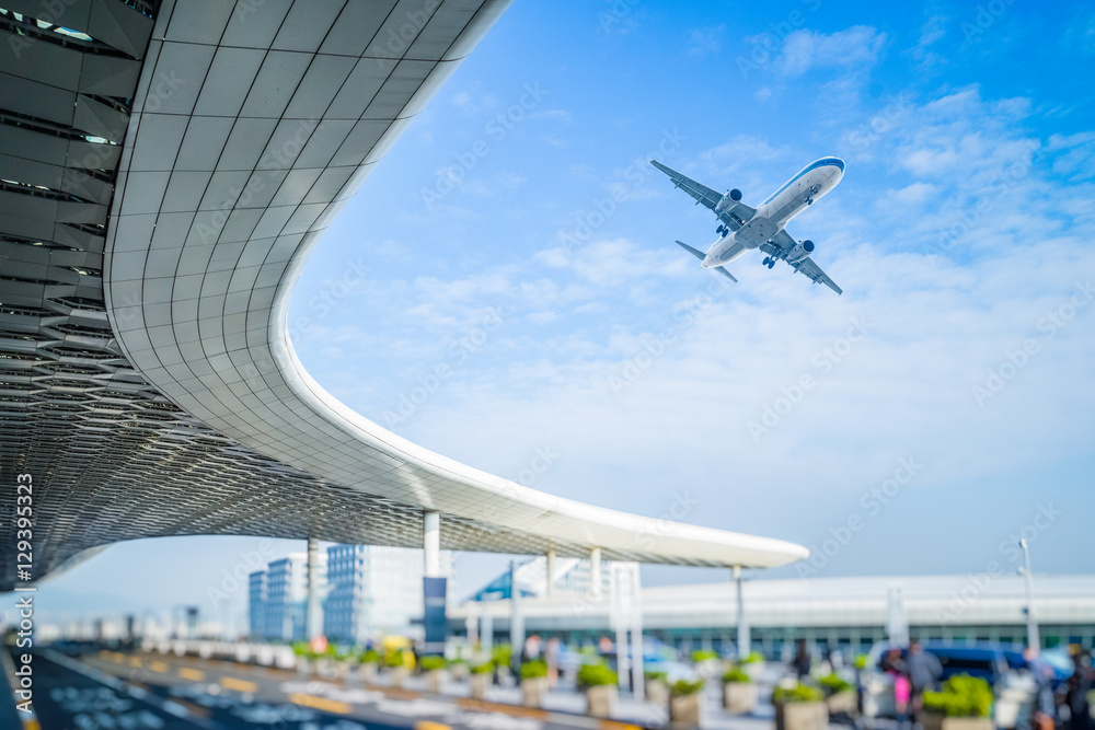 blurred street scene in city with a plane flying over. blurred street scene in city with a plane flying over.