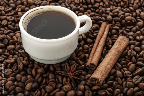Coffee cup with cinnamon and beans