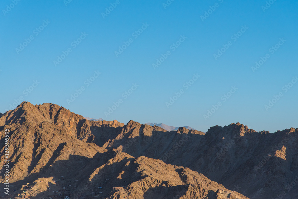 Mountain range with sunlight and blue sky