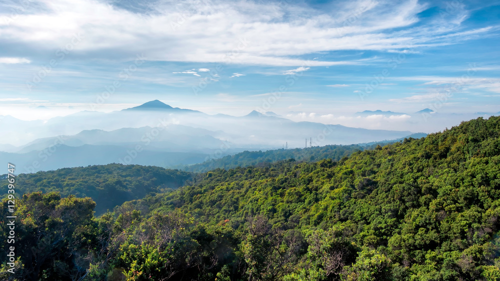 View of large area of forest, followed by misty hill and mountain, beautifully layered, seen from Tangkuban Perahu Summit, Indonesia