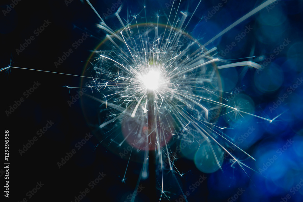 Color blue style. Christmas and New Year party sparkler with abstract circular bokeh background Christmas lights. Color blue style. Christmas and New Year party sparkler with abstract circular bokeh background Christmas lights.