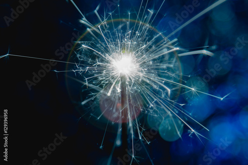 Color blue style. Christmas and New Year party sparkler with abstract circular bokeh background Christmas lights.
