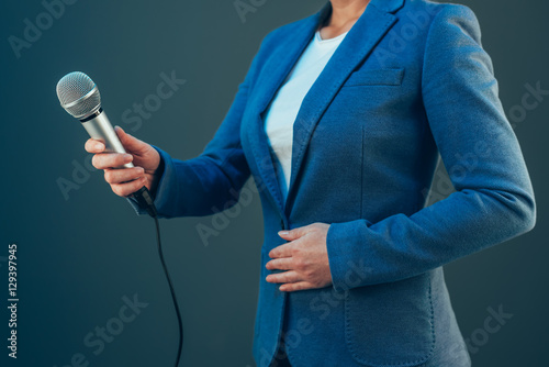 Elegant female journalist conducting business interview