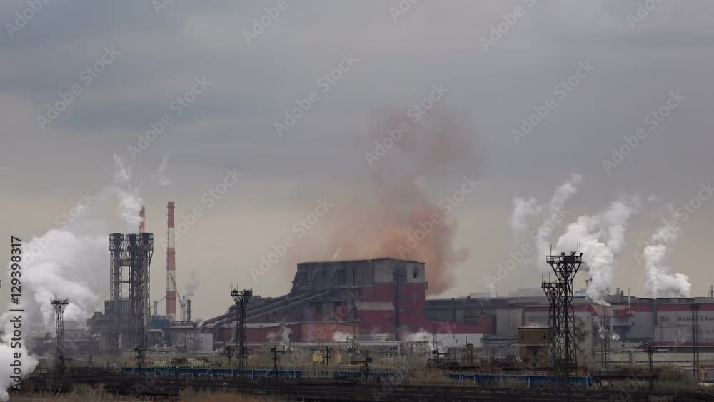 Atmospheric Air Pollution From Industrial Smoke Now. Pipes Steel Plant. Thick Smoke and Steam of Steel Production Workshops. Atmospheric Air Pollution From Industrial Smoke Now. Pipes Steel Plant. Thick Smoke and Steam of Steel Production Workshops.