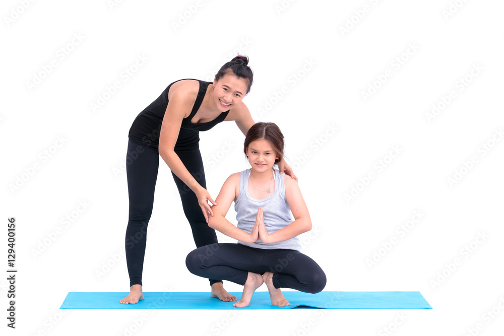 Obraz premium Smiling girl practicing yoga poses and her instructor in yoga cl