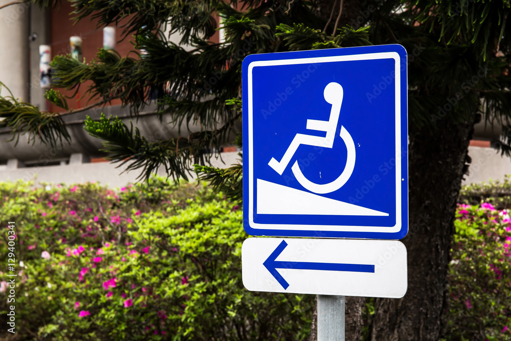 Photo &amp; Art Print A white and blue wheelchair ramp sign with an arrow ...
