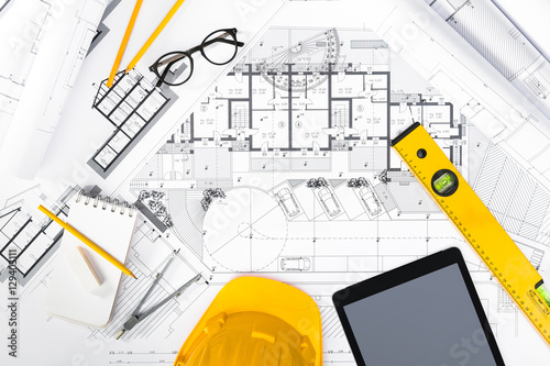 Construction plans with Tablet, drawing and working Tools on blu