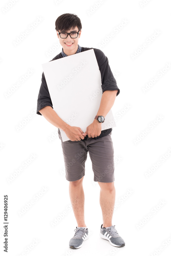 Male student holding a white board against white background. Asi Male student holding a white board against white background. Asi
