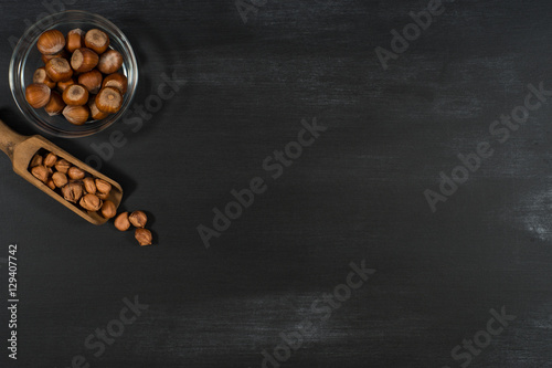 Hazelnut scoop, bowl on black chalkboard.