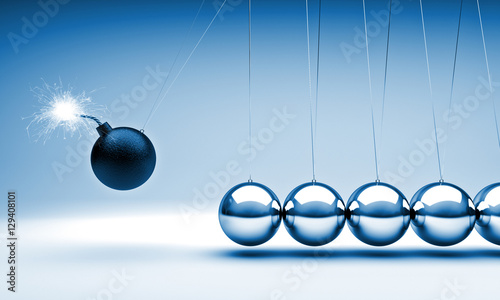  3d image of a classic newton cradle pendulum. nobody around. business concept and flowing time. the first ball is a bomb that is about to explode. lack of time. photo