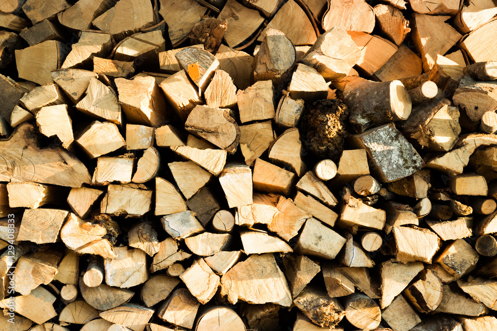 Stacked woodpile of cut and split dried logs Stacked woodpile of cut and split dried logs