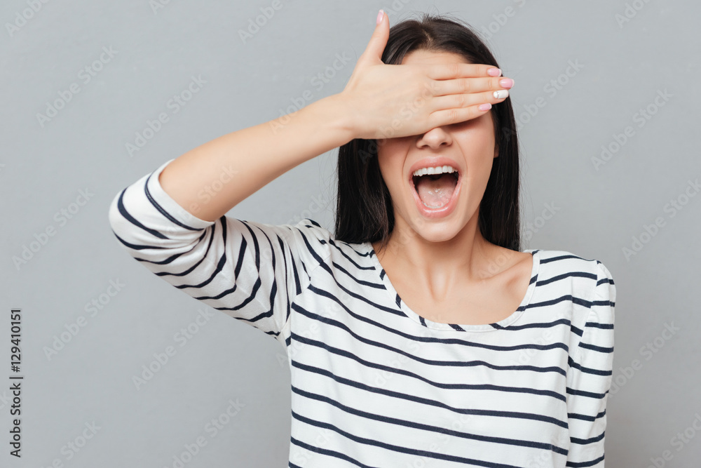 Happy young woman covering eyes. Happy young woman covering eyes.