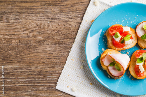 Bruschetta with tomato, cheese and bacon