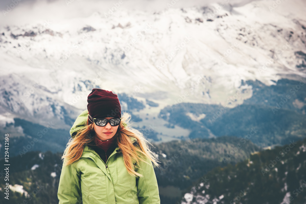 Woman Traveler walking alone Travel Lifestyle adventure concept snow big mountains on background active vacations