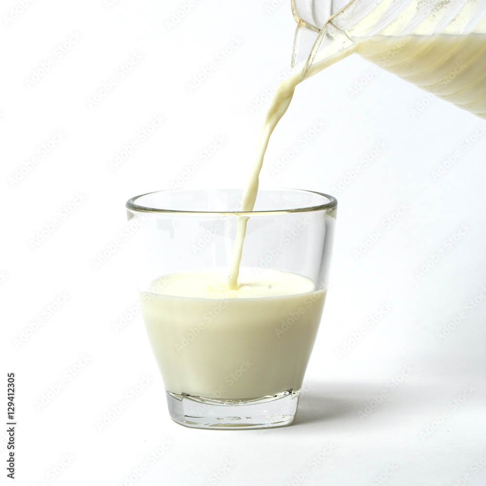 Pouring a cup of milk creating splash
