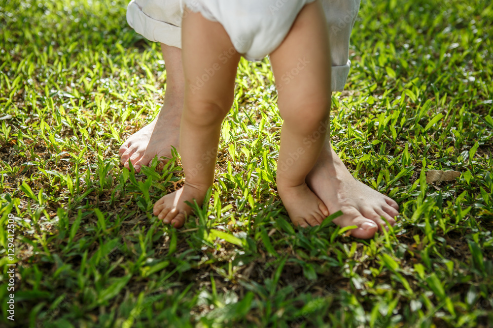 Portrait of mother and baby legs. First steps. Portrait of mother and baby legs. First steps.