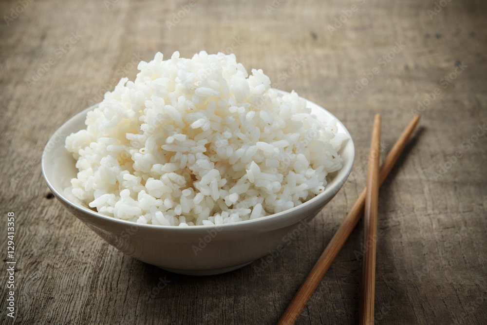 Japan rice with chopsticks on wooden background Japan rice with chopsticks on wooden background