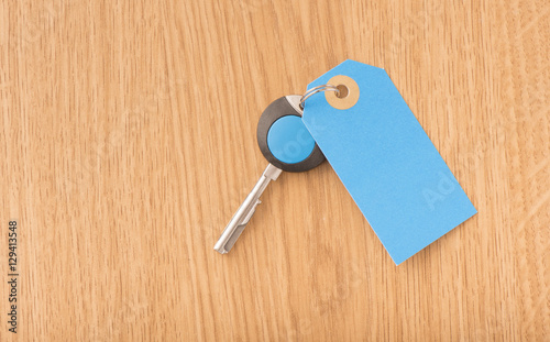 Modern key and blank label with copy space. Concept image of buying new property or home security.