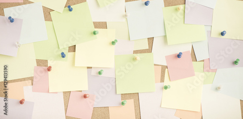 Empty blank sticky notes on notice board in office. Background or backdrop for business information. Concept image of communication or reminder with copy space.