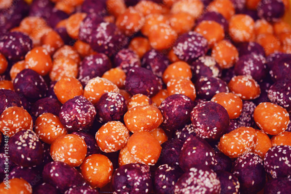 deep fried orange and purple sweet potato balls with white sesame. deep fried orange and purple sweet potato balls with white sesame.