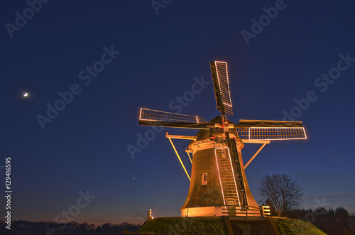 Scenic nightscape of an old mill in a winter landscape in Elspeet, The Netherlands
