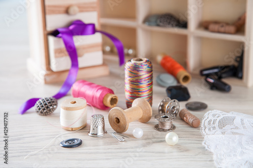 Beads,thread and bobbins for needlework.Selective focus photo