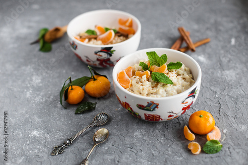 Oatmeal with tangerines in their Christmas plates
