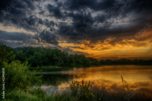Fototapeta Naklejka Na Ścianę i Meble -  Stormy Sunrise over a lake.