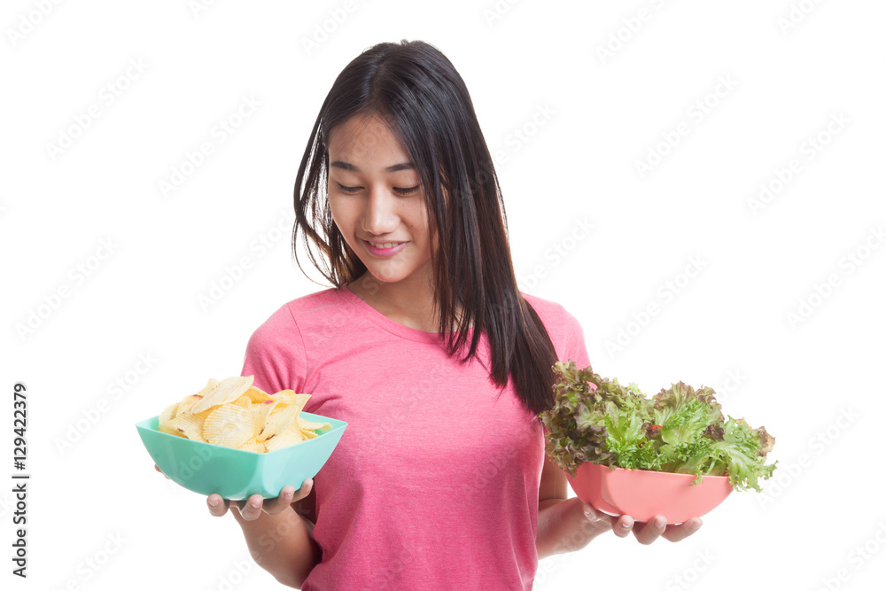 Young Asian woman with potato chips and salad. Young Asian woman with potato chips and salad.