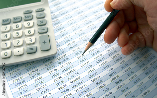 Checking through accounts with pencil and calculator
