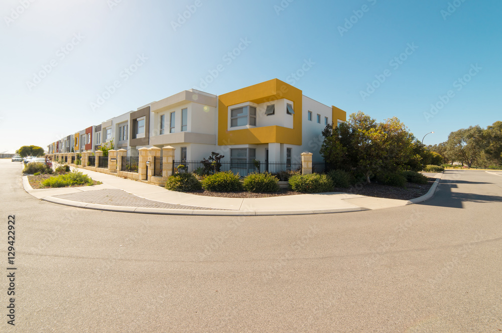Asphalt road with modern terrace house in front on blue sky background. Yanchep Beach Town , Perth , Western Australia . Asphalt road with modern terrace house in front on blue sky background. Yanchep Beach Town , Perth , Western Australia .