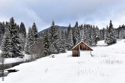 Alpine house covered with snow in the mountains © salajean