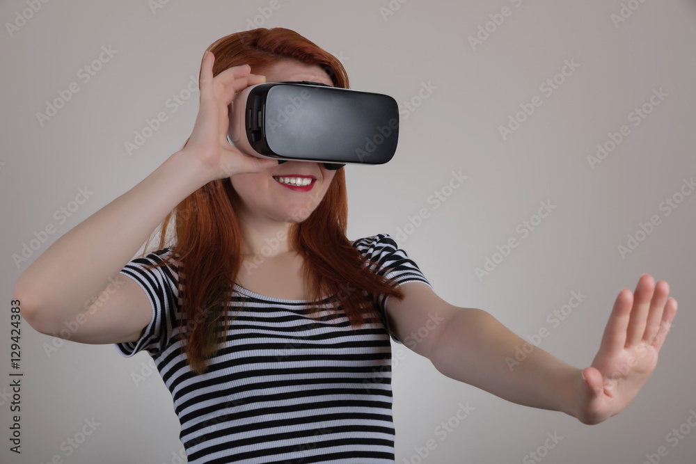 Redhead woman using a virtual reality headset Redhead woman using a virtual reality headset