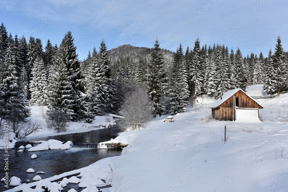 Alpine house covered with snow in the mountains
