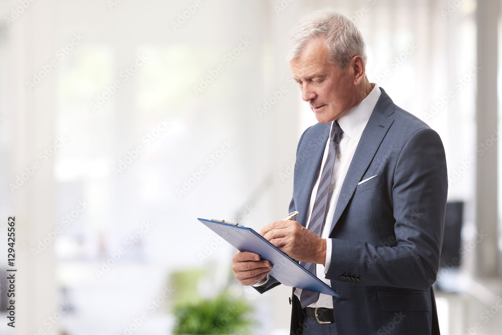 Senior professional man working in the office Senior professional man working in the office