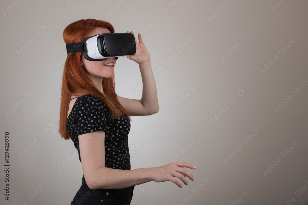 Attractive woman wearing virtual reality goggles. VR headset. Virtual reality concept Attractive woman wearing virtual reality goggles. VR headset. Virtual reality concept