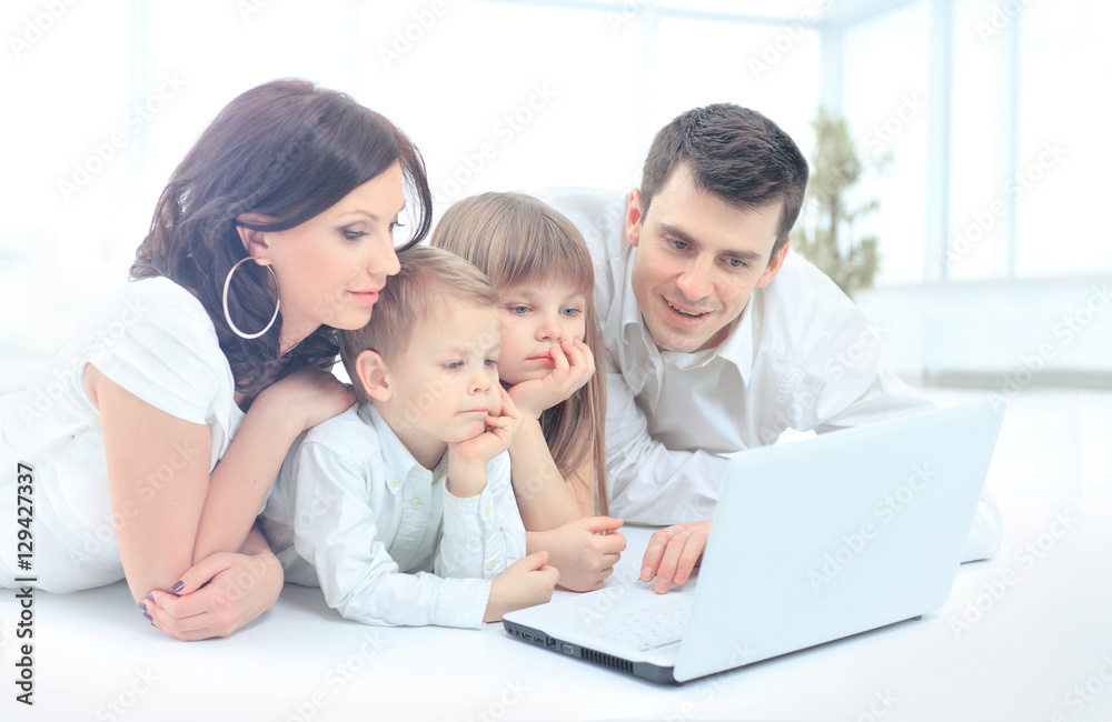 family looking into the laptop enthusiastically family looking into the laptop enthusiastically
