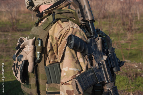 close up picture of rifle on soldier neck
