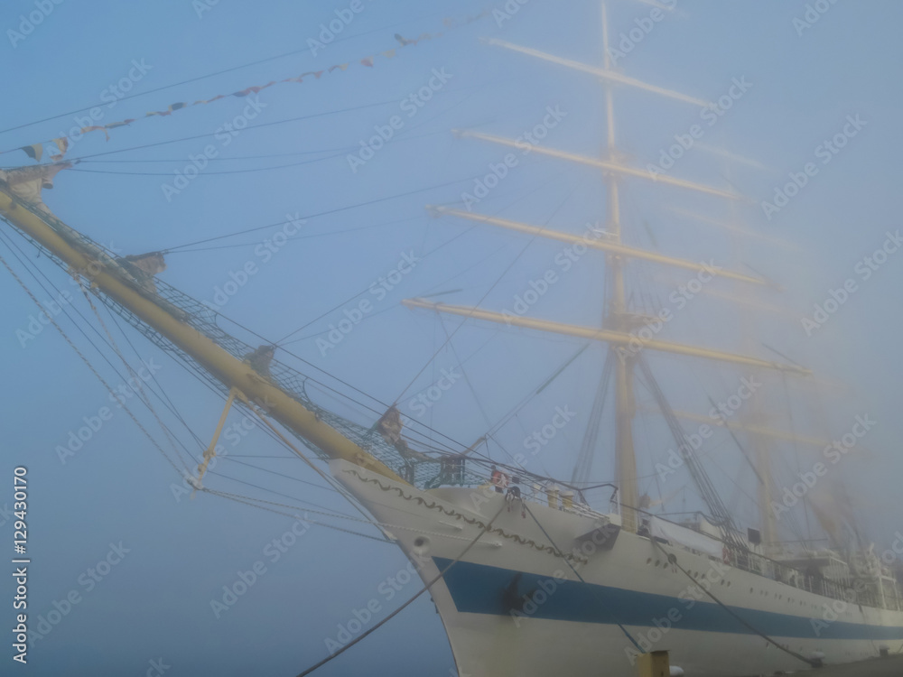 Old sailing ship at the mooring in fog. Varna, Bulgaria