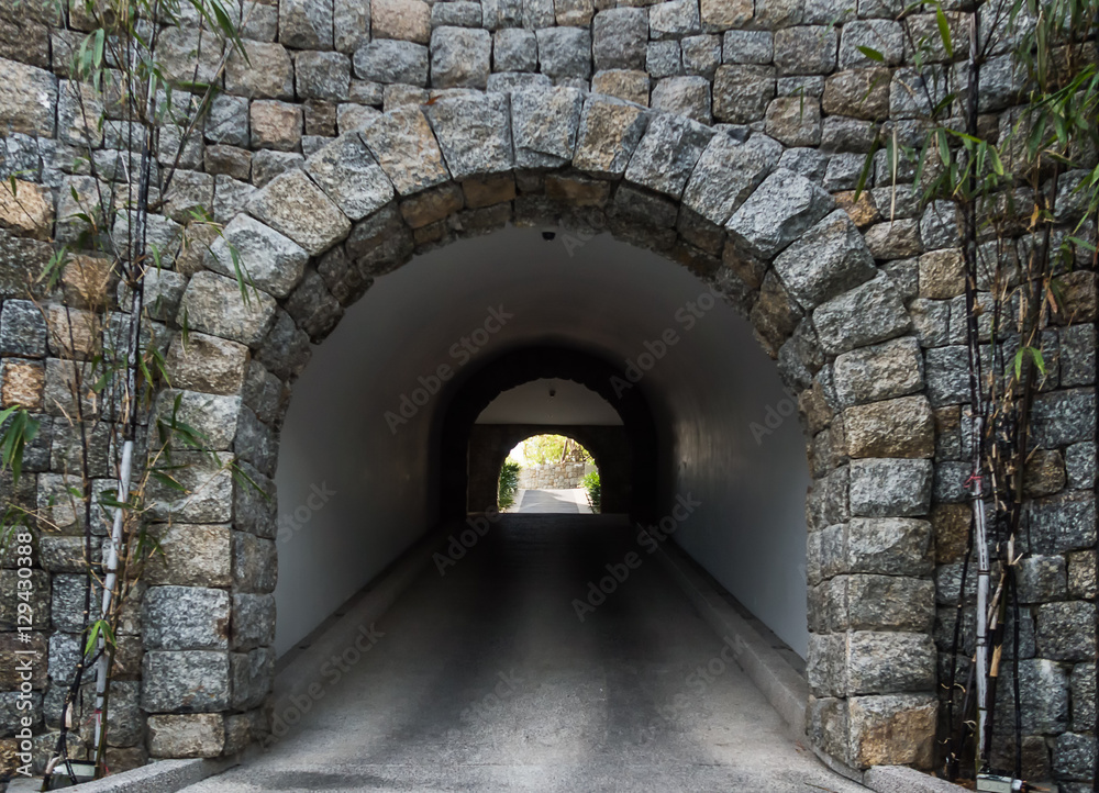 Stone tunnel with light coming from the exit.Business concept
