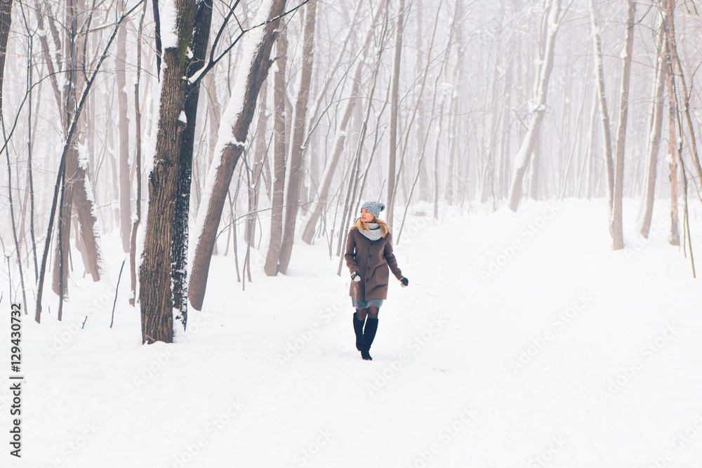 Beautiful young girl in a white winter forest