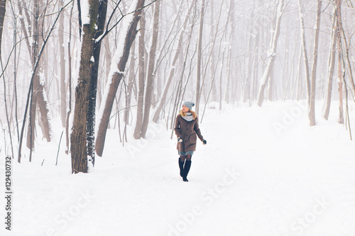 Beautiful young girl in a white winter forest
