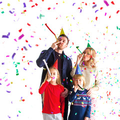 Family blowing party trumpets